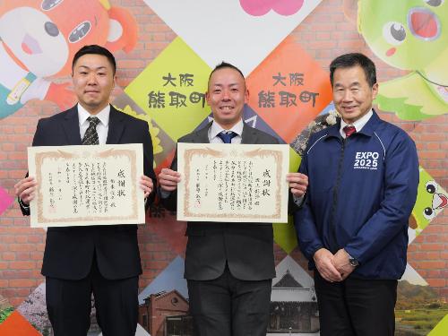 感謝状を手に町長と記念撮影する熊取町青年団団長と副団長