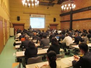 セミナー会場で、前方の画面を注目している参加者の後ろ姿の写真