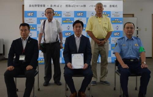 久間会長、北川会長が後ろ側で立ち、町長、富岡社長、高安署長が前で椅子に座って撮影された集合写真