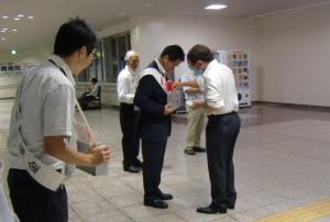 熊取駅構内での赤い羽根共同募金に参加している人達の写真
